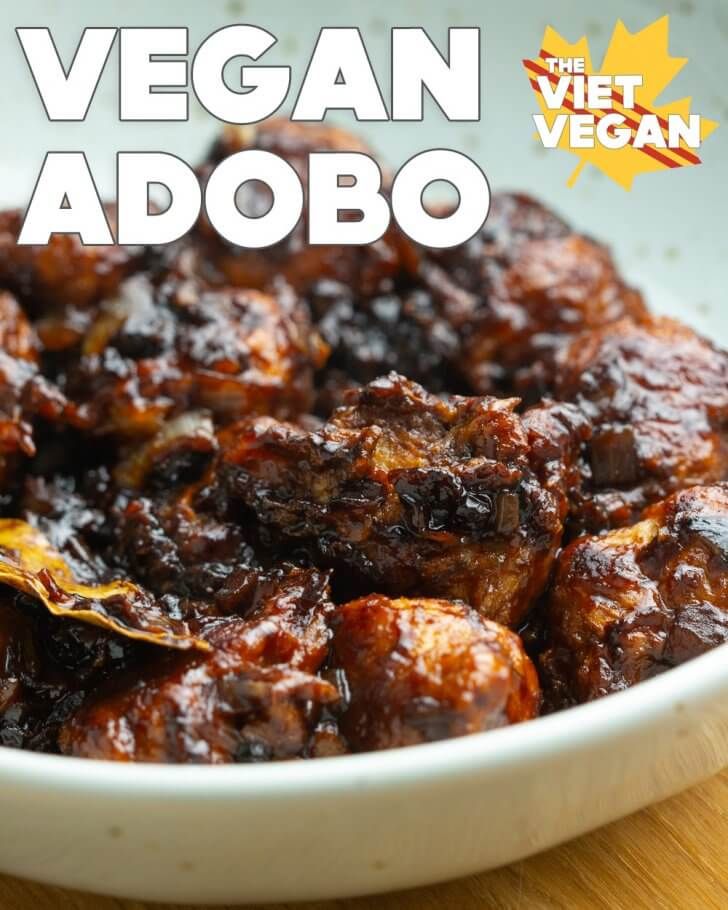 the vegan adobo is in a white bowl on a wooden table with text overlay