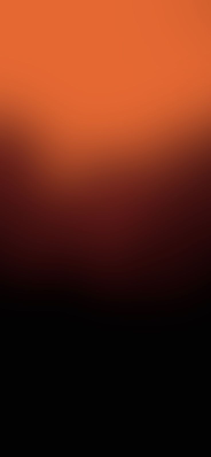 an orange and black blurry background with the light reflecting off it's side