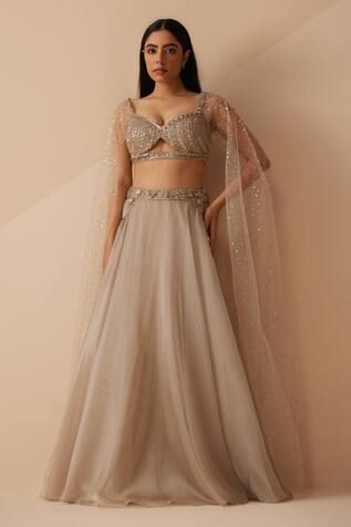 Grey attached cancan lehenga with side pockets and pearls, cutdana embroidered waistband. Paired with a padded blouse with all over pearls, sequins, cutdana embroidery.
Components: 2
Pattern: Embroidery
Type Of Work: Pearls, Sequins, Cutdana
Neckline: Sweetheart neck
Sleeve Type: Cape Sleeves
Fabric: Organza
Color: Grey
Other Details: 
Length: Lehenga: 45 inches
Attached cancan
Padded blouse

Occasion: Sangeet - Aza Fashions Luxury Lehenga With Unstitched Blouse For Celebration, Luxury Lehenga With Cutdana And Cape Sleeves, Luxury Elegant Choli With Cutdana, Luxury Party Lehenga With Draped Sleeves, Luxury Cutdana Draped Lehenga, Luxury Bollywood Lehenga With Cape Sleeves, Luxury Satin Lehenga For Reception, Luxury Georgette Choli With Draped Sleeves, Luxury Party Lehenga With Cape Sleeves