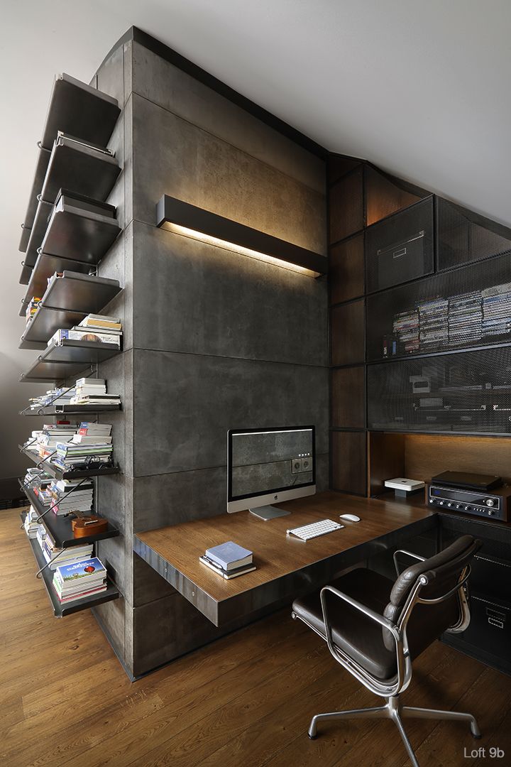 an office area with a desk, chair and bookshelf on the wall next to it