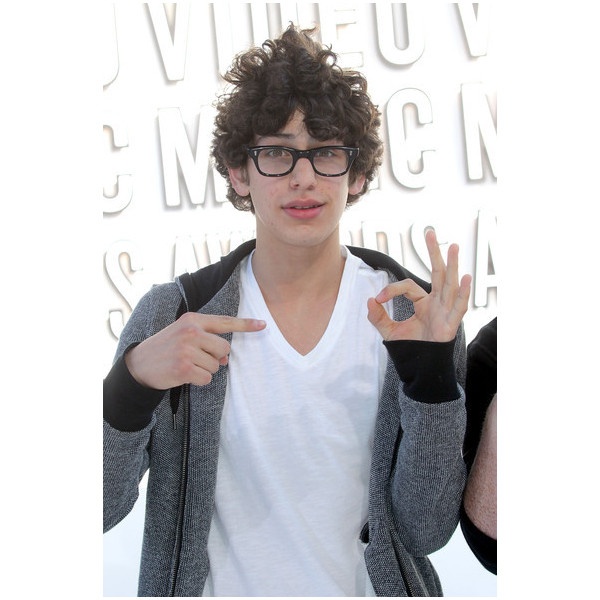 a young man with glasses making the peace sign