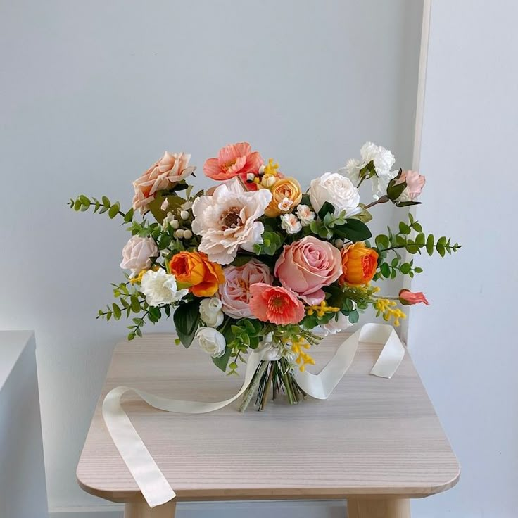 a bouquet of flowers sitting on top of a wooden table