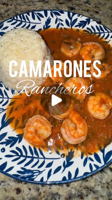 a blue and white plate topped with rice and shrimp