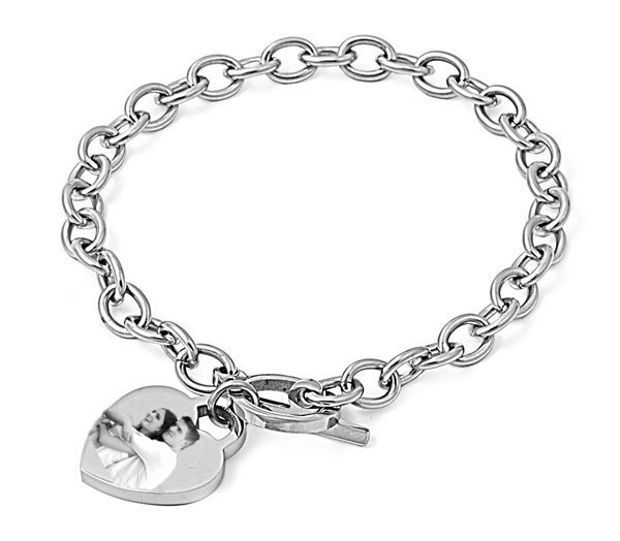 Looking for a stylish bracelet with charm? Seek no further than this bracelet. The heart charm hanging loosely on the bracelet gives it an exhilarating appeal. The stainless steel make brings out the lustrous feel to keep your wrist more conspicuous. It’s a nice bracelet that can make a perfect match with lots of apparel designs. Whether going out for a prom or friend’s birthday party, it can complement your dress code seamlessly. Personalized Engraved Gifts, Medical Bracelet, Jewellery Marketing, Stylish Bracelet, Toggle Bracelet, Engraved Gifts, Photo Heart, Stainless Steel Rings, Heart Bracelet