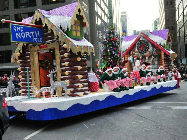 a float with gingerbread houses and santa clause on it's side in a parade