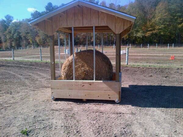 a small wooden shelter with hay in it