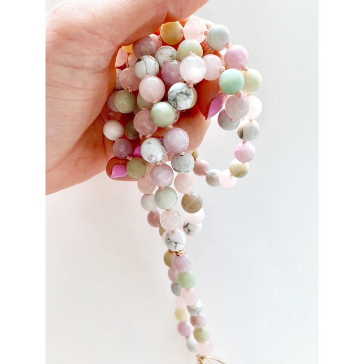 This dreamy mala necklace is filled with airy pastel colors and beautiful light energy. This 108 mala necklace is composed of Amazonite, Rose Quartz, Kunzite, Howlite and a Rainbow Moonstone Guru Crystal. Strung on a pink silk cord with Rose Gold Accents giving it a touch of tenderness and ooze with feminine energy. All Malas are saged to cleanse the energy before they are shipped to their new home. G E M S T O N E P R O P E R T I E S ♥ KUNZITE is a powerful healer of the emotional body, particu Pink Meditation Necklaces With Round Beads, Pink Round Beads Necklace For Meditation, Pink Round Beads Necklaces For Meditation, Spiritual Pink Beaded Necklaces With Natural Stones, Spiritual Pink Crystal Necklaces With Round Beads, Handmade Pink Crystal Necklace For Meditation, Pink Natural Stones Beaded Necklace For Healing, Pink Spiritual Hand Wrapped Necklaces, Hand Wrapped Pink Spiritual Necklaces