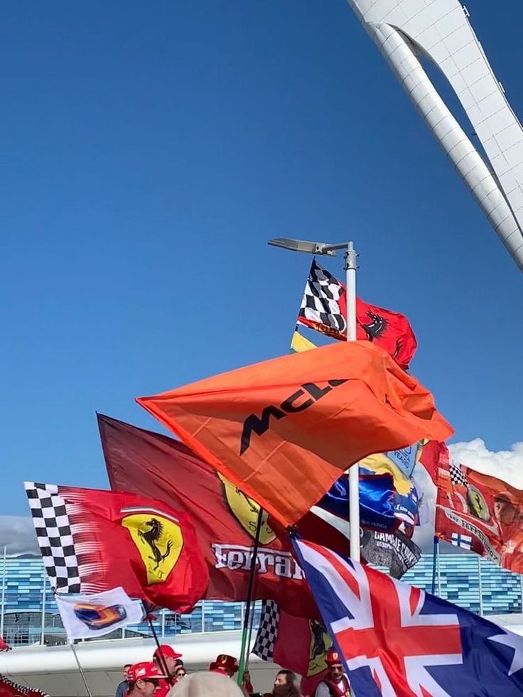 many flags are flying in the wind on a boat