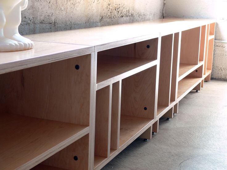 a white shelf with some drawers on it