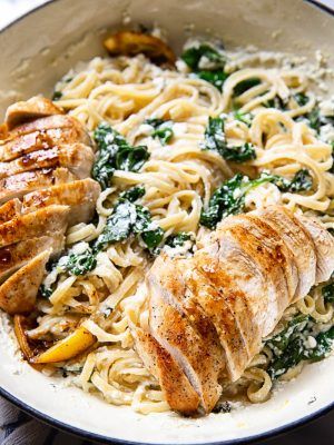 chicken, spinach and pasta in a white bowl