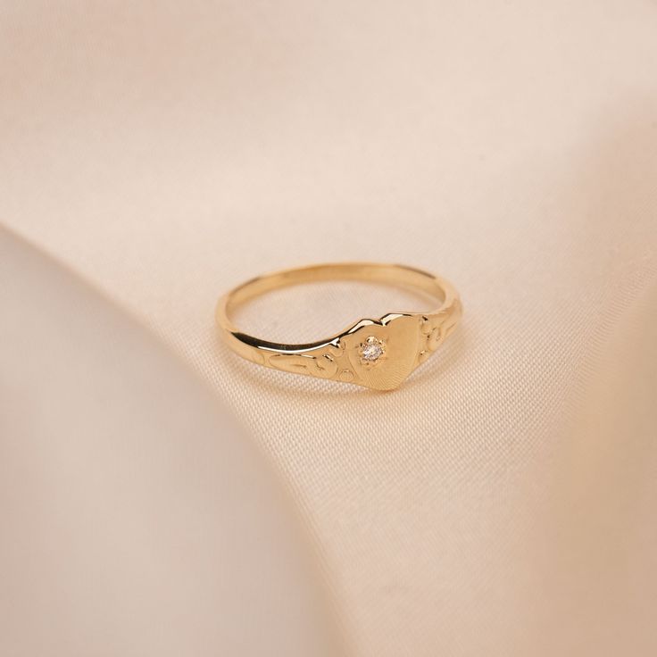 14k Gold Vintage Diamond Heart Signet (closed back). Pinky, meet our new Vintage inspired Diamond Heart Signet Ring. We're loving how dainty it is and the diamond that brings just a little bit of extra shimmer. 14k Solid Gold .01 CTW Built to last a lifetime and more. Handmade to order. Please allow an additional 5 - 7 days for processing. Dainty Birthstone Ring With Diamond Accents, Heirloom 14k Gold Heart Promise Ring, 14k Gold Signet Ring With Bezel Setting For Promise, Heirloom 14k Gold Signet Ring With Birthstone, Dainty Engraved 14k Gold Ring, Dainty Yellow Gold Signet Ring For Promise, Classic Wedding Signet Ring With Birthstone, Heirloom Birthstone Signet Ring For Anniversary, Heirloom Signet Ring With Birthstone For Anniversary