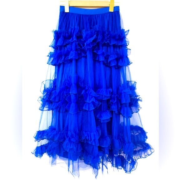 Indulge In The Dreamy Allure Of This Vibrant Blue Tulle Skirt. Crafted With Layers Of Soft And Airy Tulle, It Embodies A Sense Of Charm. The Rich Blue Hue Adds A Pop Of Color To Your Ensemble, While The Comfortable Elastic Waistband Ensures A Flattering Fit. Whether It's A Casual Day Out Or A Special Event, This Tulle Skirt Is Your Ticket To Effortless Elegance. Blue Tulle Bottoms For Spring, Spring Blue Tulle Bottoms, Blue Tulle Party Bottoms, Blue Tulle Skirt For Summer, Spring Flowy Skirt With Attached Cancan, Blue Tulle Maxi Skirt For Party, Blue Long Tulle Skirt, Blue Tulle Party Maxi Skirt, Party Blue Tulle Maxi Skirt