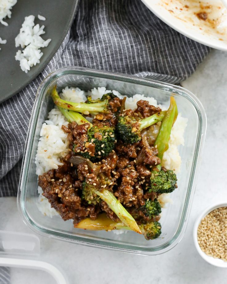 the meal is prepared and ready to be eaten on the table with rice, broccoli, and other items