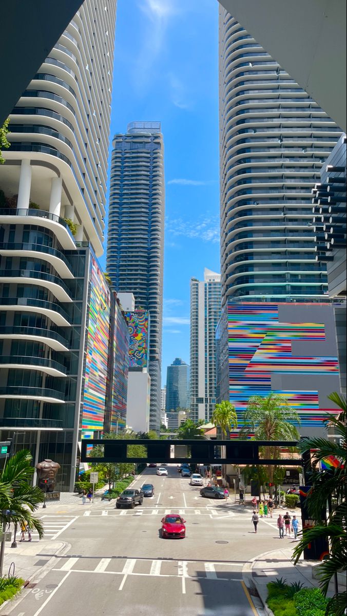 an empty city street with tall buildings in the background