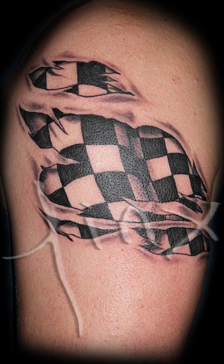 a black and white checkered tattoo on the arm