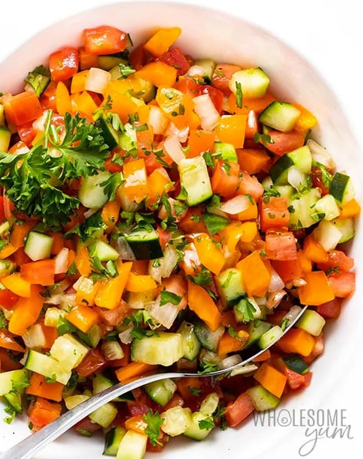 a white bowl filled with chopped vegetables on top of a table