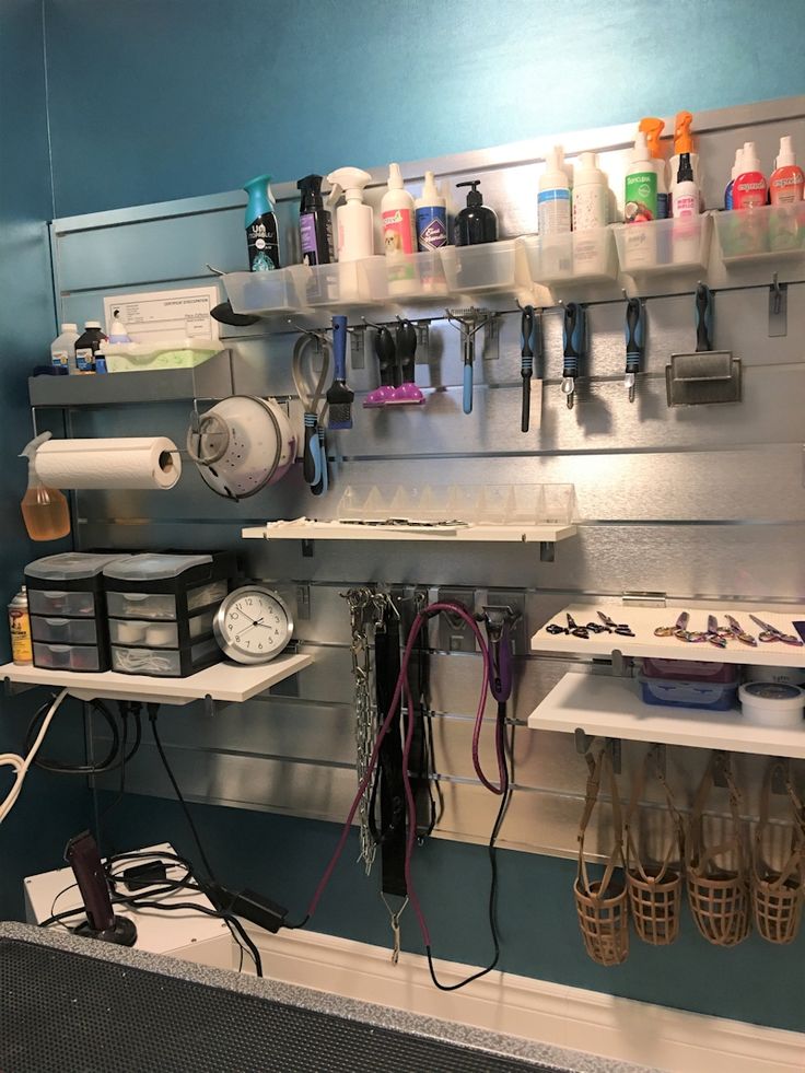 there are many different items on the shelf in this room, including hairdryers and combs