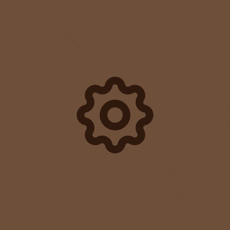 a brown background with a black and white image of a cogwheel on it