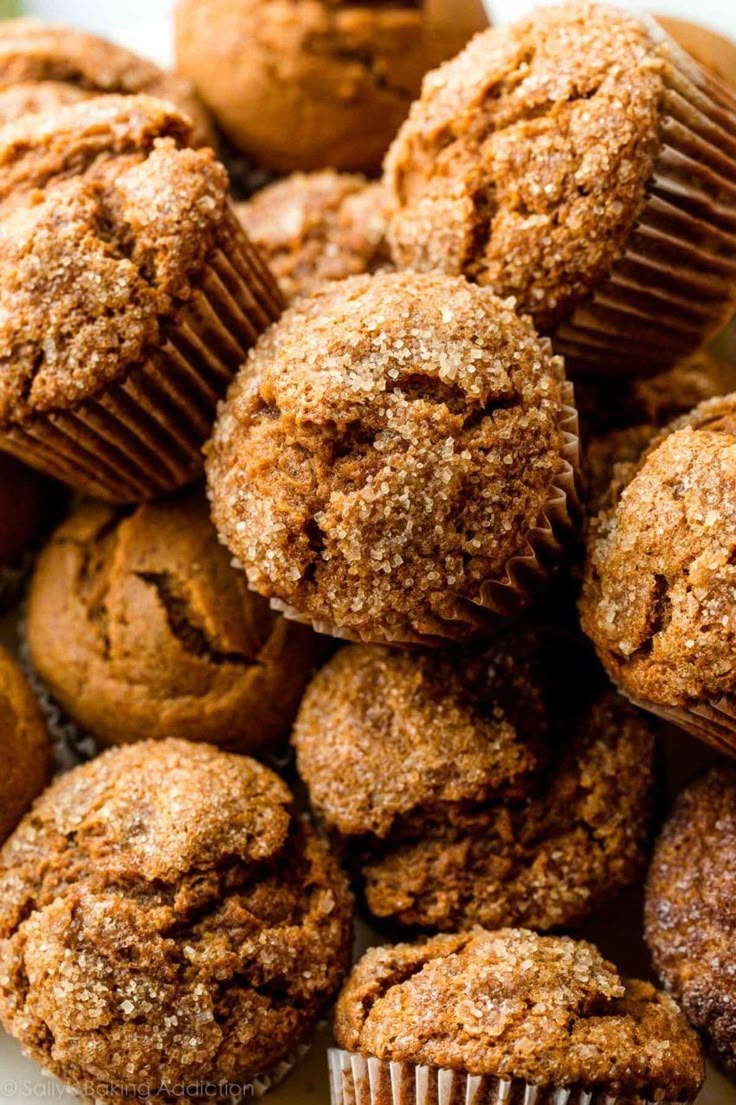 a pile of muffins sitting on top of a white plate