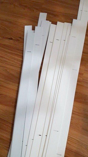 several pieces of white paper sitting on top of a wooden floor