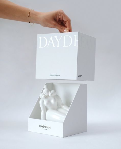 a white box with the word david on it is held up by a woman's hand