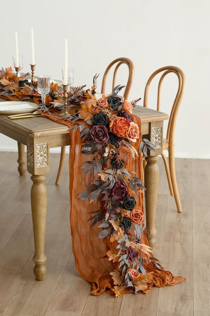 the table is decorated with flowers and candles for an elegant touch to the dining room