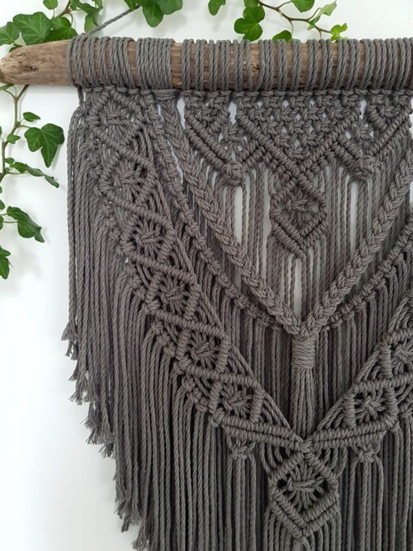 a close up of a macrame wall hanging