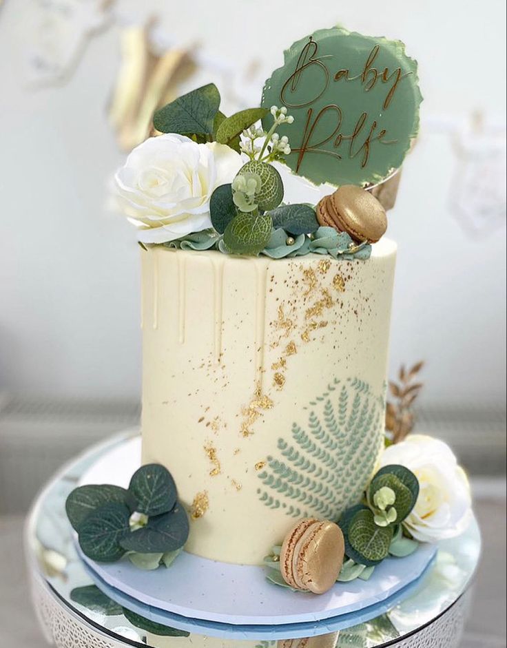 there is a cake that has been decorated with flowers and leaves