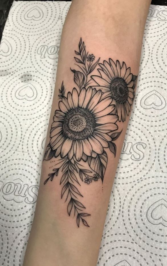 a sunflower tattoo on the arm