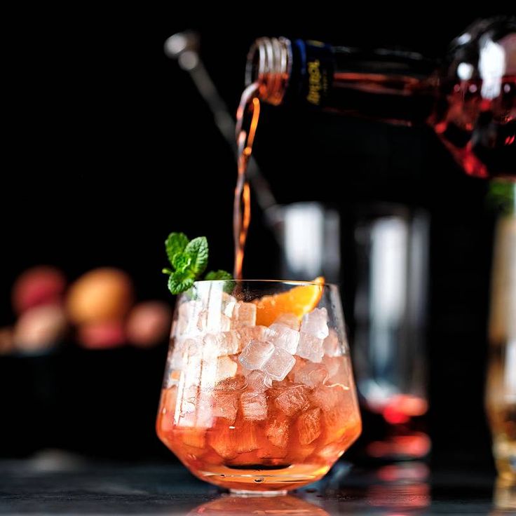 a glass filled with ice and orange slices