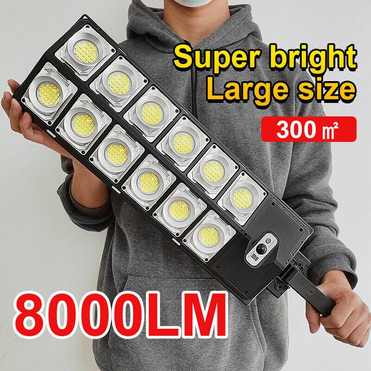 a young boy holding a light fixture with the words super bright large size on it