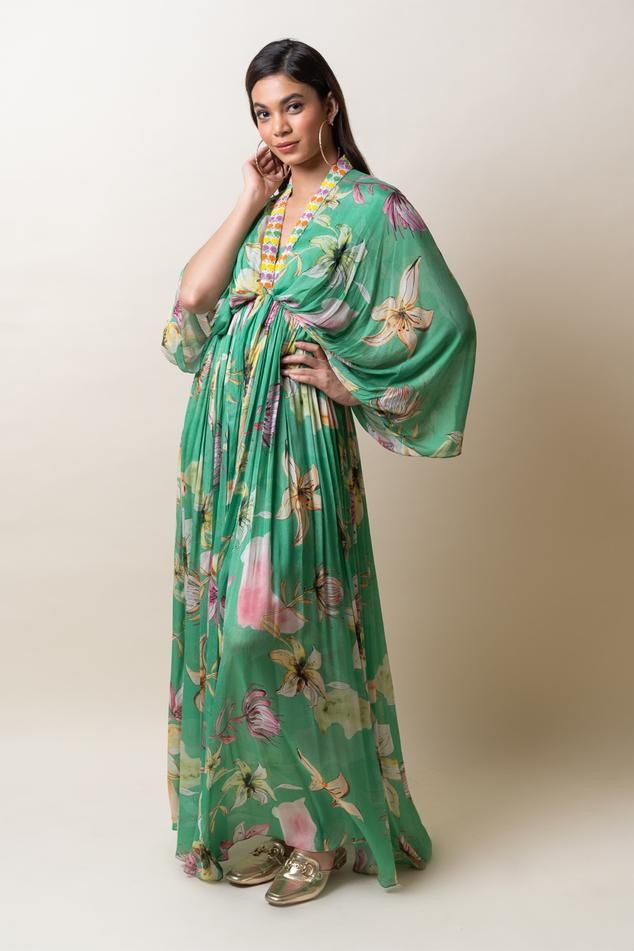 Green chiffon kaftan dress with floral print and sequins hand embroidered placket and neckline. Comes with an inner.
Components: 2
Pattern: Printed, Hand embroidered
Type Of Work: Floral, Sequins
Neckline: V Neck
Sleeve Type: Flared Sleeves
Fabric: Chiffon
Color: Green
Other Details: 
Length : Dress - 57 inches
Occasion: Party - Aza Fashions V Neck Kaftan, Chiffon Kaftan, Kaftan Dress, Floral Chiffon, Flared Sleeves, Aza Fashion, Sleeve Type, Green Dress, Dresses Online