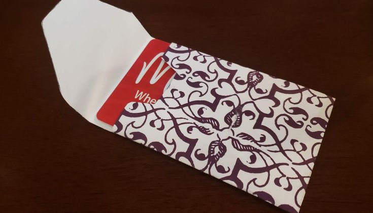 a mcdonald's napkin with a red and white design on it sitting on a table