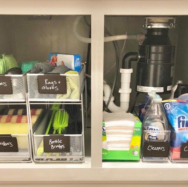 two bins filled with cleaning supplies on top of a shelf