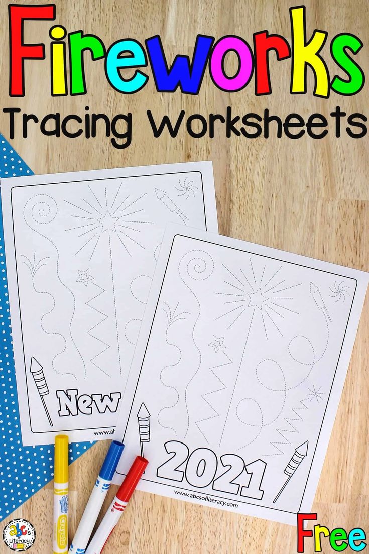 two firework worksheets on a wooden table with crayons and markers