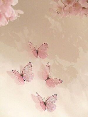 three pink butterflies flying in the air with flowers around them on a white wallpapered background