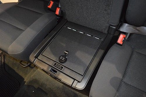 the interior of a car with two seats and an electronic device in the center console