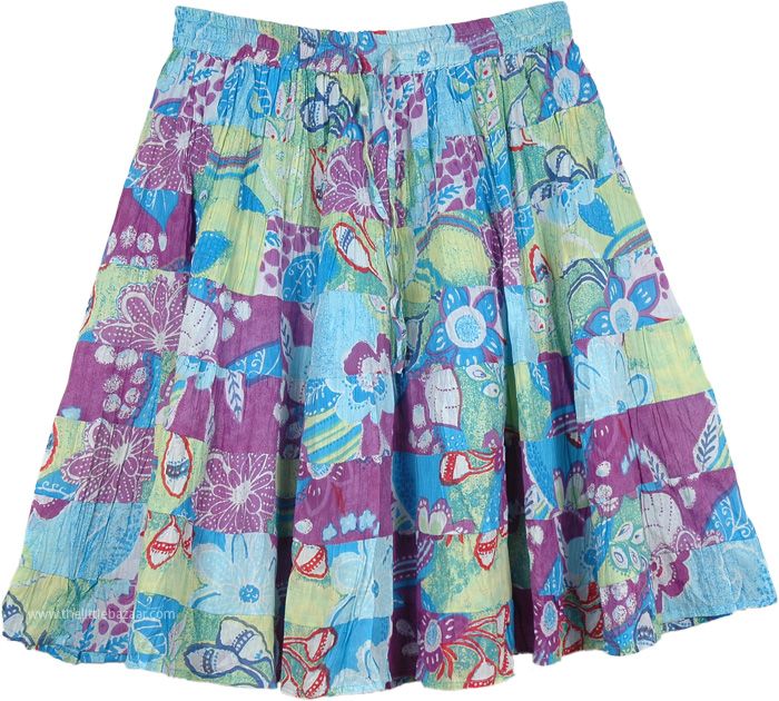 Tiered Floral Blue Cotton Skirt - A summer paradise blooms on this 8 tiered flowing, bouncy, flouncy unique one-of-a-kind style in short skirts. A feminine beauty an absolutely awesome cheerful color scheme in purple and blue. The horizontal patchwork pattern looks great on this short length skirt with a lot of fabric to go around, 8 wonderful vibrant tiers. It features an elastic waist with a flexible drawstring. This chic skirt can be dressed up or down with flat shoes or high heels and you ca Spring Multicolor Flowy Skirt, Flowy Multicolor Skirt For Spring, Bohemian Blue Tiered Bottoms, Blue Bohemian Tiered Bottoms, Blue Tiered Skirt For Summer, Bohemian Tiered Multicolor Skirt, Green Tiered Mini Skirt For Summer, Green Tiered Beach Skirt, Tiered Green Beach Skirt