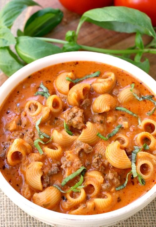 a white bowl filled with pasta and meat sauce