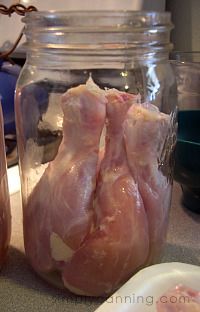 two jars filled with raw chicken sitting on top of a counter