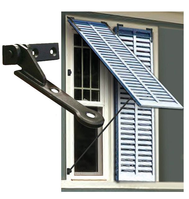 an open window with shutters on the side and a door handle attached to it