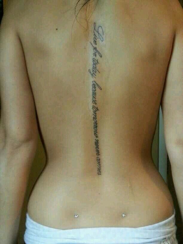 the back of a woman's upper body with writing on her left side and lower back