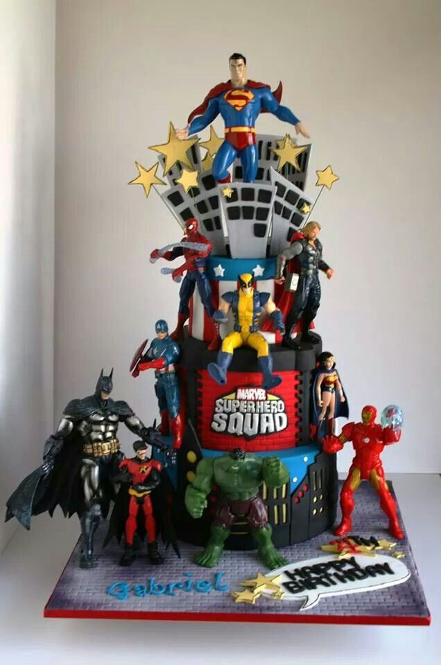 a birthday cake made to look like batman and other superheros are on top of it