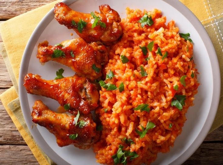 chicken wings and rice on a white plate