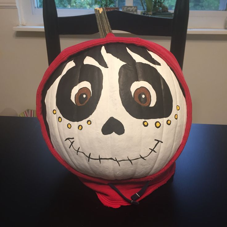 a pumpkin decorated to look like a jack - o'- lantern sitting on top of a table