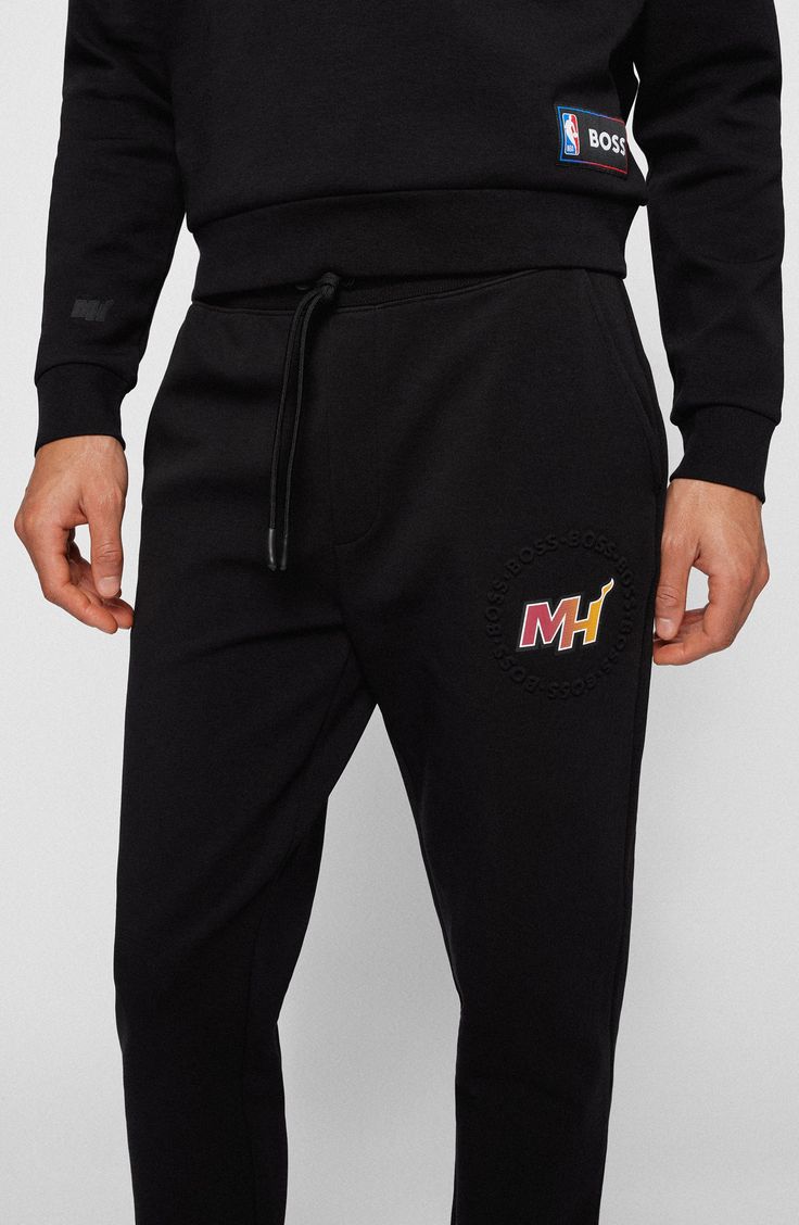 It's easy to rep your favorite team in the stands or on the streets in logo-marked sweatpants made for comfort from a soft, stretchy cotton blend. 83% cotton, 14% polyester, 3% elastane Machine wash, line dry Made in Turkey Casual Black Bottoms With Logo, Casual Logo Pants For Streetwear, Sporty Pants With Logo Print For Sports, Black Casual Pants For Sports Events, Black Logo Bottoms For Sports, Athleisure Joggers With Logo Detail For Sports, Black Sportswear Sweatpants For Sports Events, Black Sweatpants For Sports Events, Black Sporty Sweatpants For Sports Events