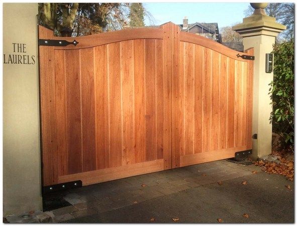 a large wooden gate in front of a house