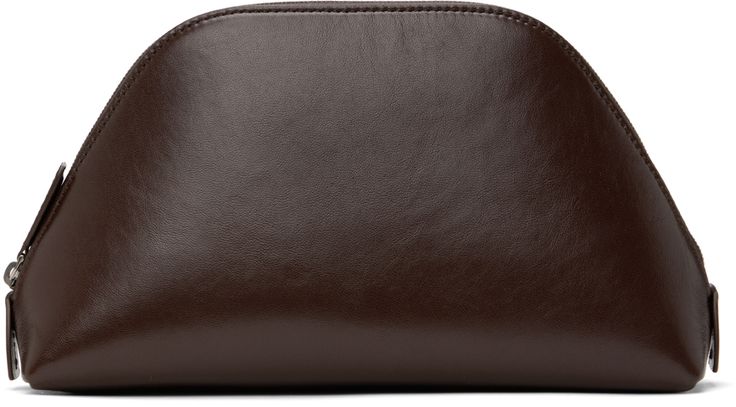 Buffed sheepskin pouch in brown. · Logo embossed at face · Zip closure · Buffed leather lining · H5.5 x W9.25 x D2.75 Supplier color: Chocolate Brown Textured Leather Clutch For Formal Occasions, Luxury Brown Soft Leather Clutch, Formal Brown Textured Leather Clutch, Brown Leather Evening Pouch, Evening Brown Leather Pouch, Elegant Brown Leather Pouch, Classic Brown Soft Leather Clutch, Brown Leather-lined Pouch Clutch, Classic Brown Clutch With Leather Lining