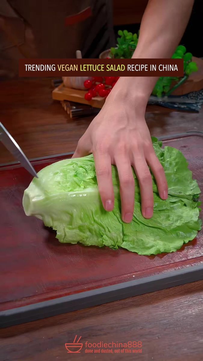 a person cutting lettuce with a knife