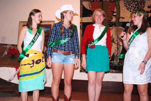 four women in costumes are standing together